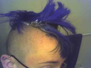 photo of the author from the ears and eyebrows up. the edge of the mohawk has a white paste on it, as it is at the beginning of the bleaching process